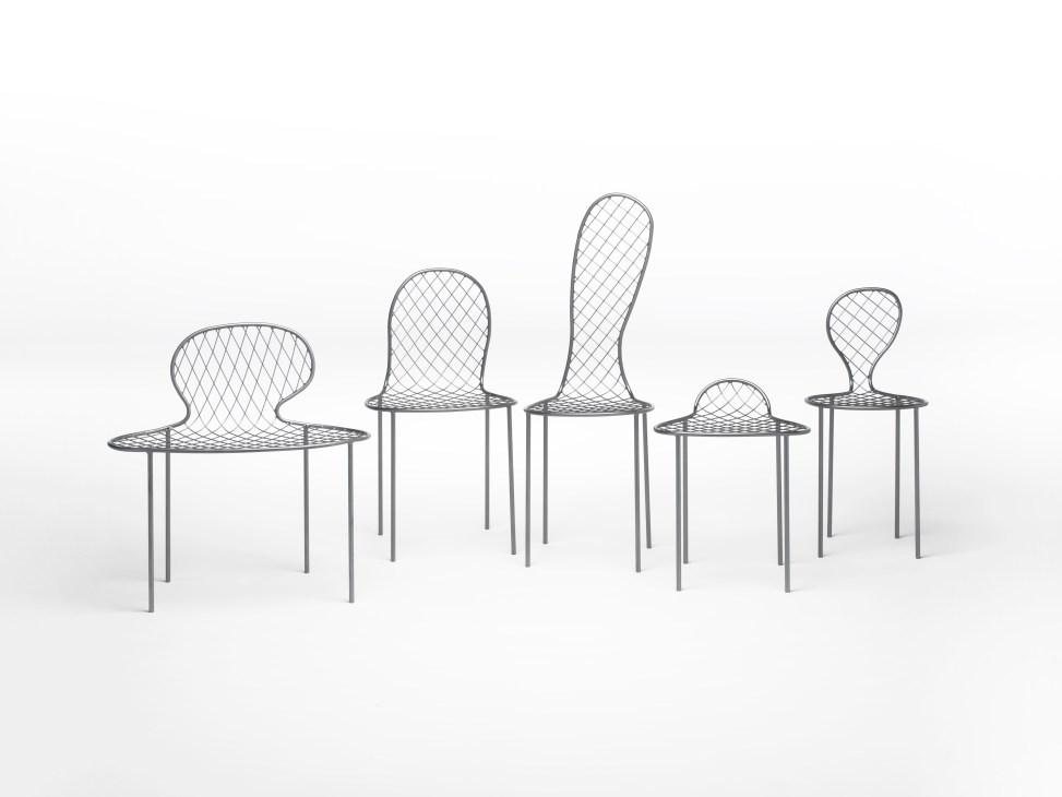 Five metal chairs in varying sizes with mesh seats and backs, arranged in a row on white background.