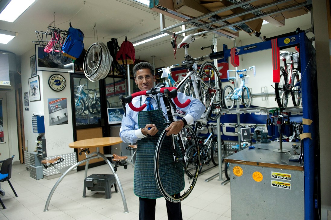 Maxime Chaya holding a bicycle in his outdoor sports and bicycle store in Lebanon.
