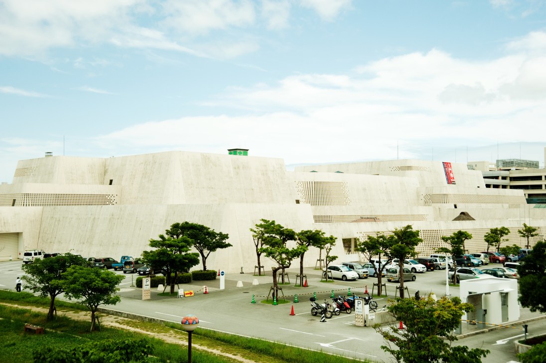 White modernist building with distinctive perforated facade of Okinawa Prefectural Museum & Art Museum.