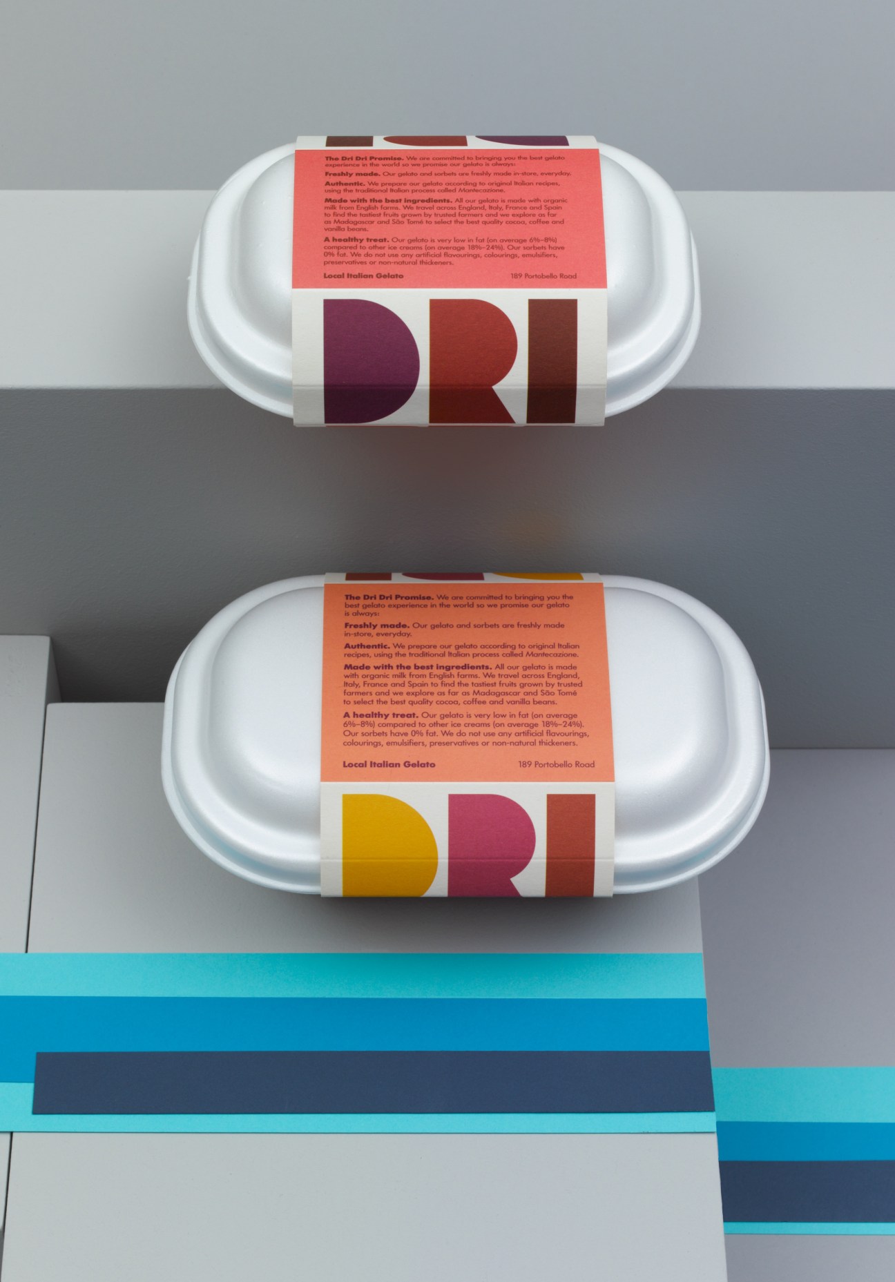 Two Dri Dri gelato containers with colorful branded labels on white takeaway boxes.
