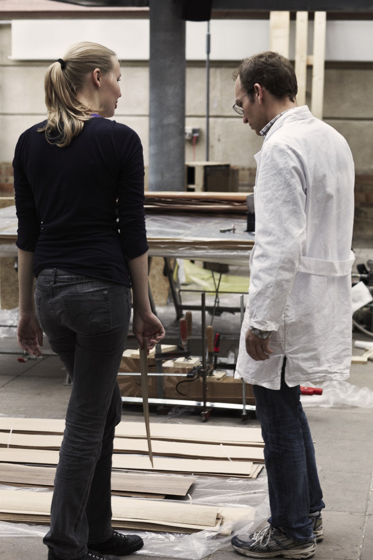 A teacher and student discuss furniture design in a workshop at the Danish Design School.