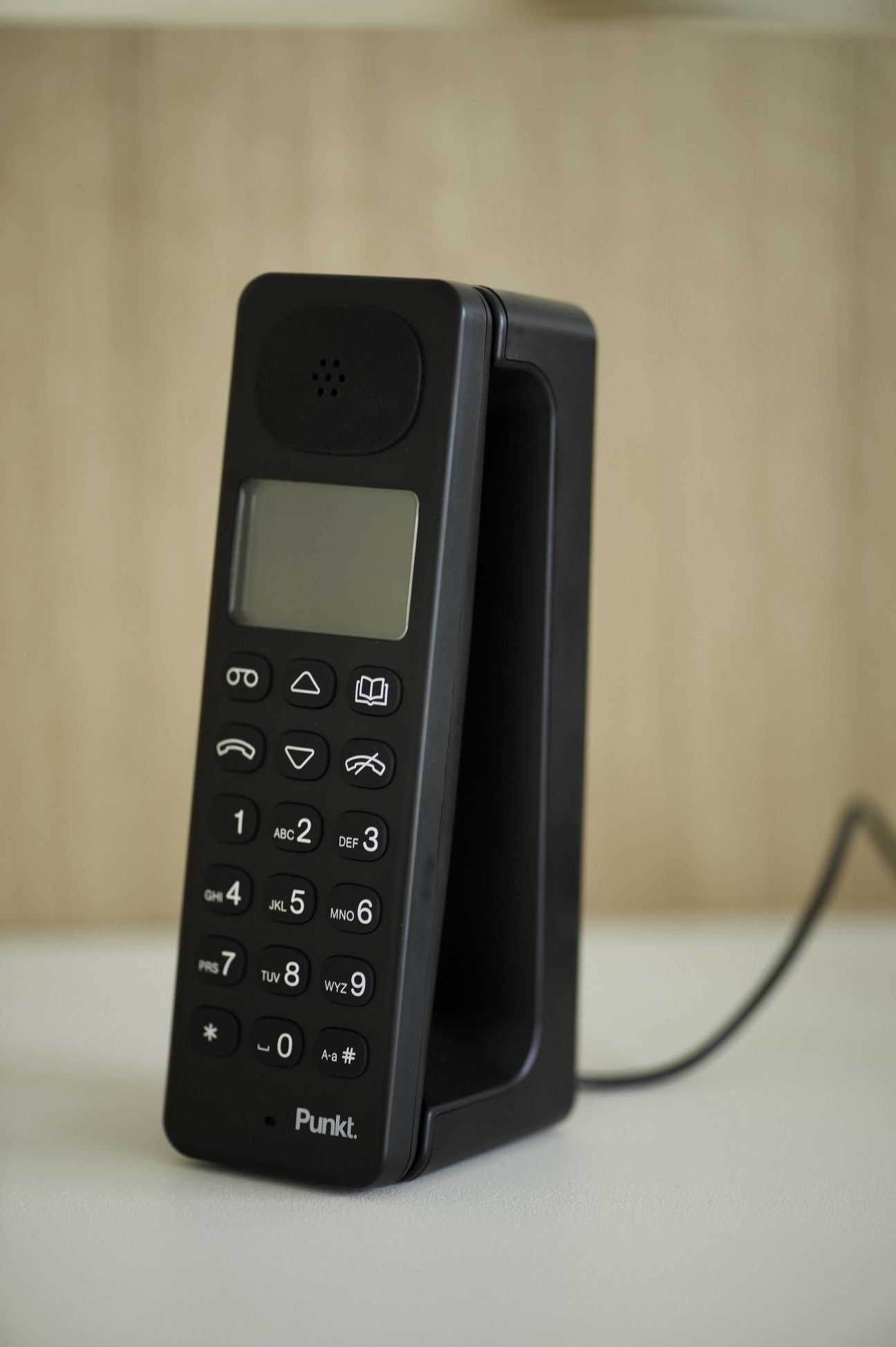 Punkt's DP 01 black cordless phone with numeric keypad and small display screen.