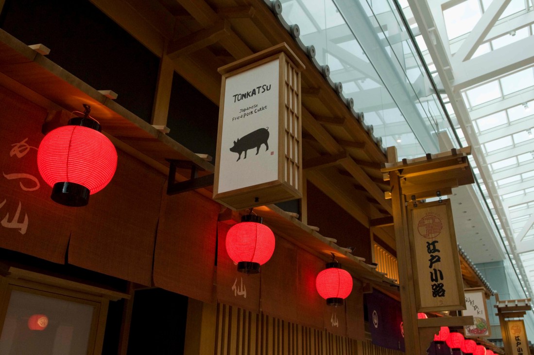 Tonkatsu restaurant storefront in Edo Koji with red lanterns and traditional Japanese wooden architecture.
