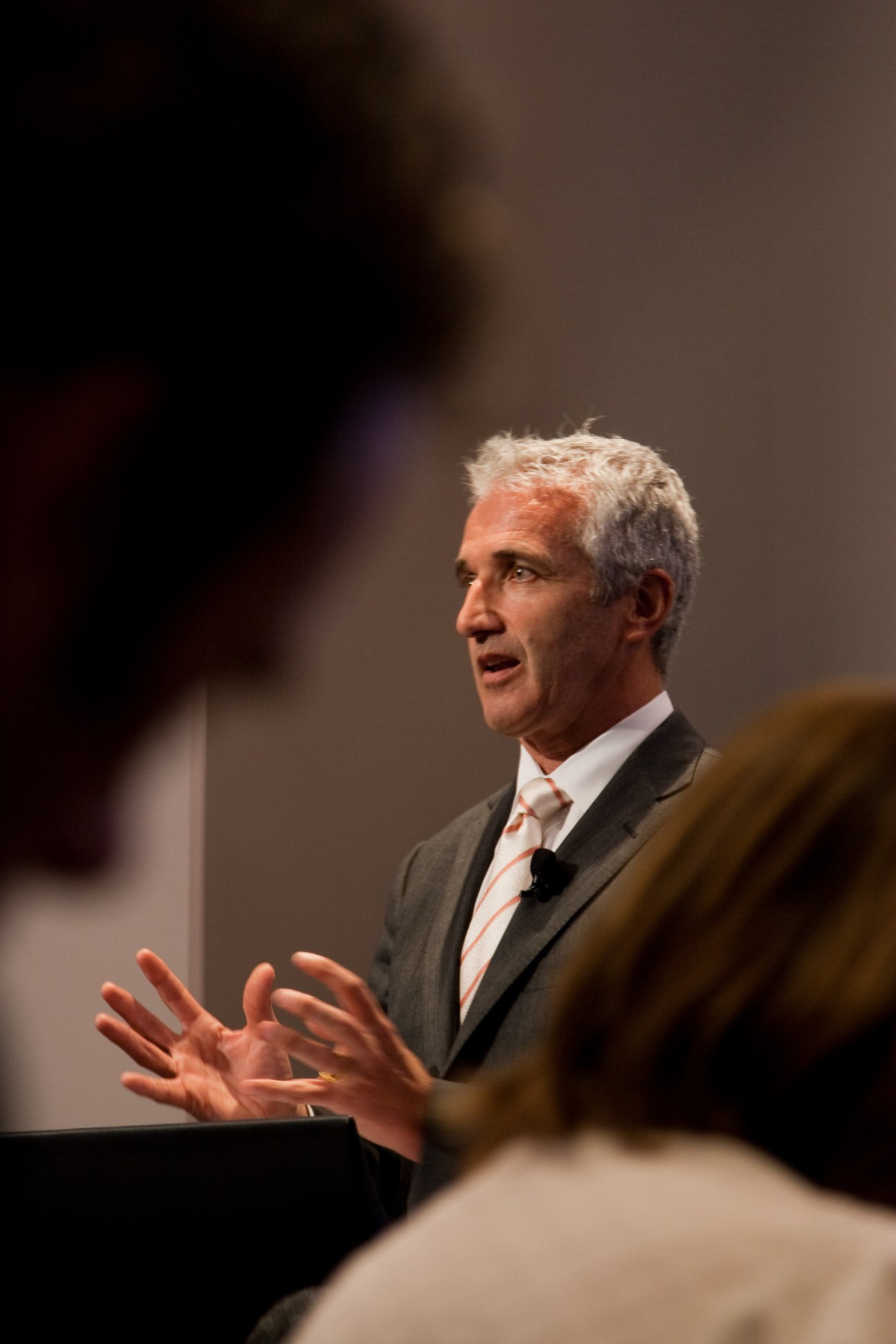 Rob Fyfe, CEO of Air New Zealand, speaking at a presentation with hand gestures.