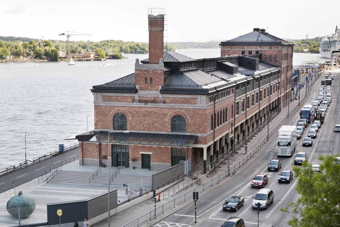 Fotografiska museum exterior, a red brick waterfront building in Sweden with a tall tower and modern additions.