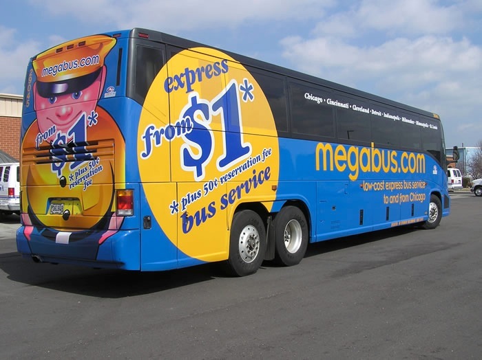 A blue and yellow megabus with cartoon character branding and express service advertising on its side.