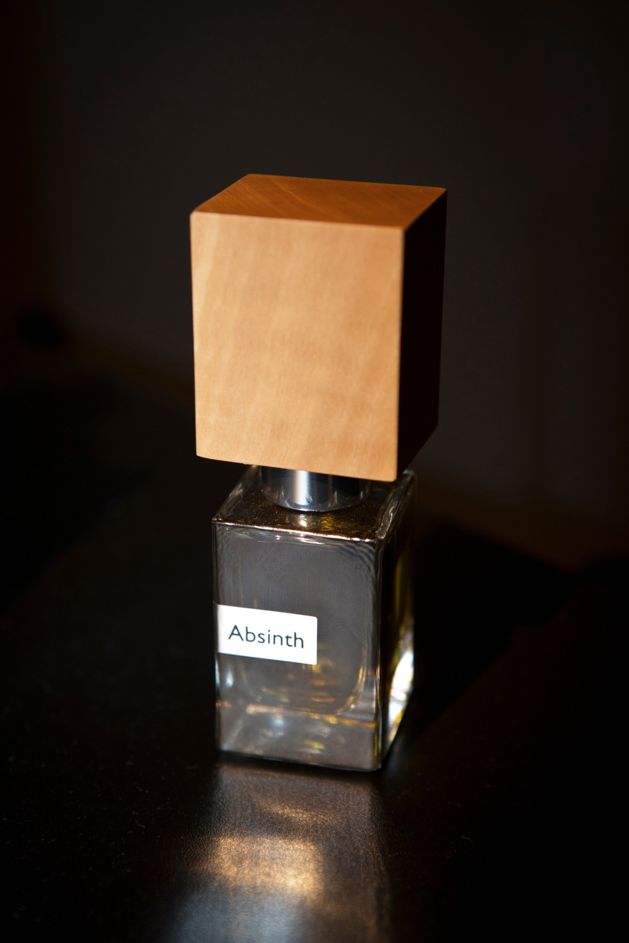 Nasomatto perfume bottle with square glass base and wooden cap labeled Absinth.