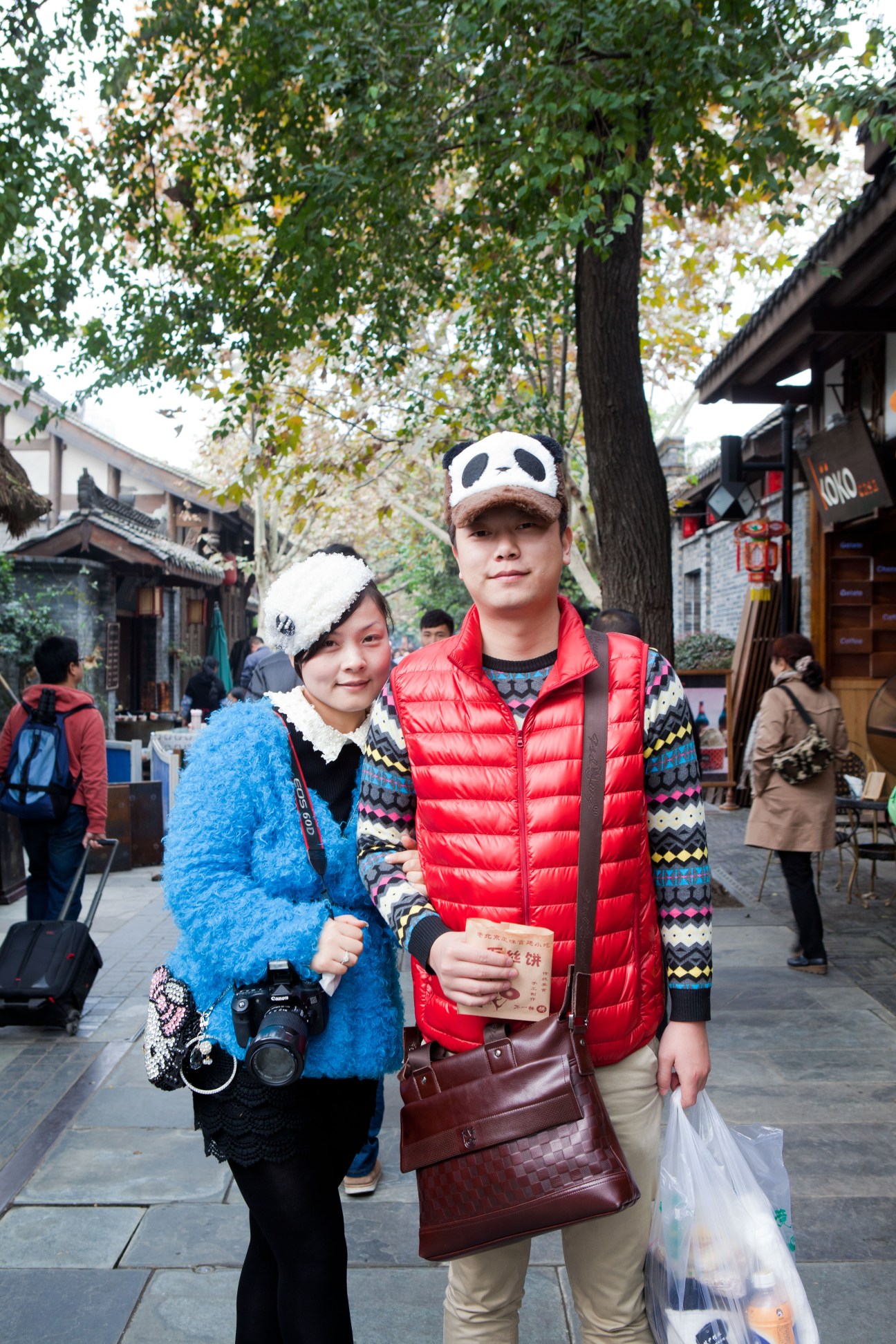 Two young visitors wearing panda-themed caps at Kuanzhai Alleys shopping street in Chengdu