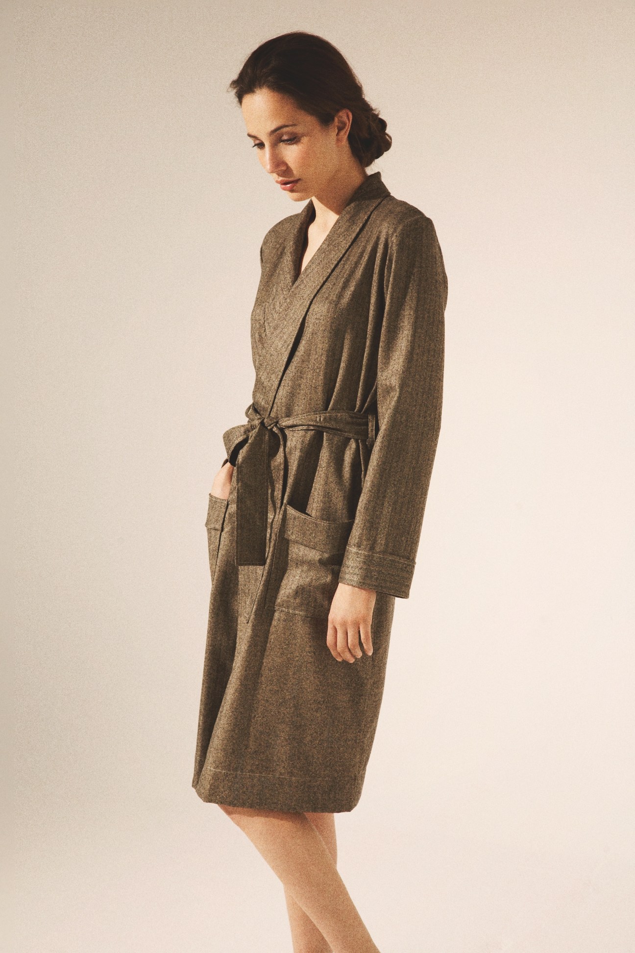 Woman wearing a belted olive-green dressing gown from Matters of Leisure.