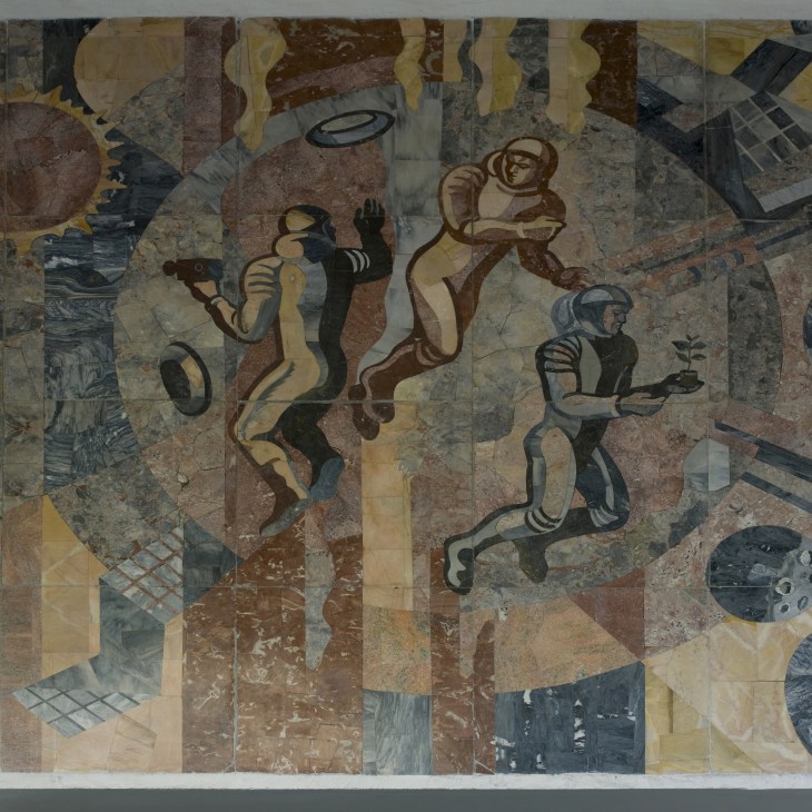 Soviet-style fresco mural depicting stylized figures in brown and cream tones outside a metro entrance.