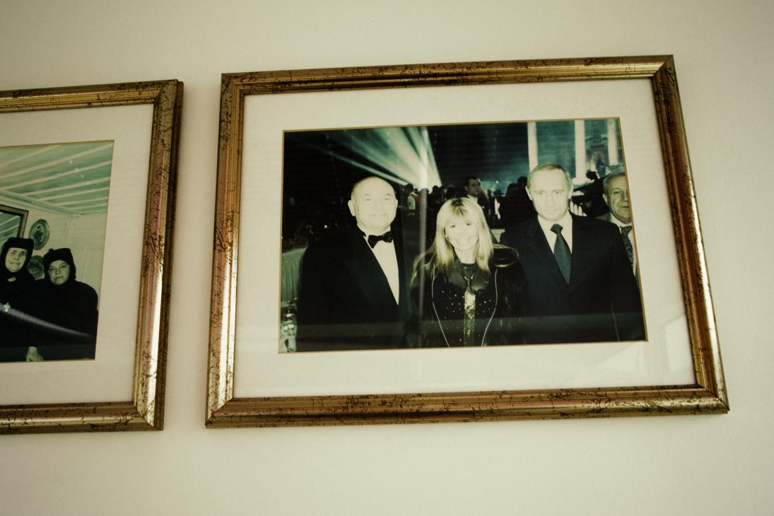 Framed photograph of Lili Ivanova flanked by Moscow mayor Yury Luzhkov and Vladimir Putin at a formal event.
