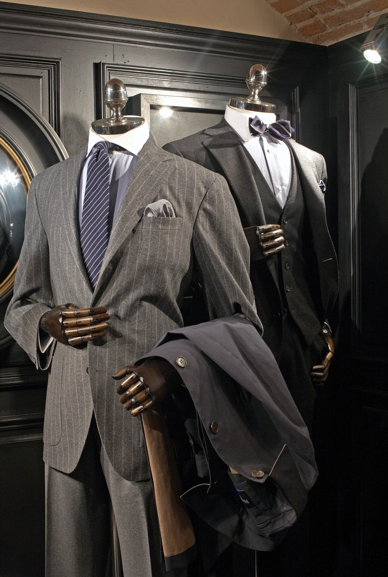 Mannequins display tailored menswear suits and blazers with dress shirts and accessories at Hackett's stand.