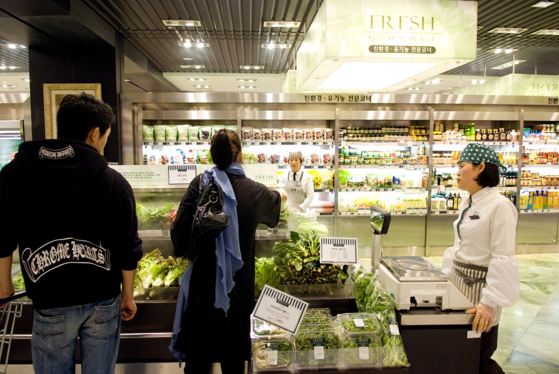 Interior of Gourmet Emporium at Galleria department store with fresh produce counter and customers