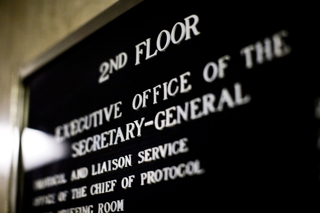 A dark signage plaque at UN headquarters reading '2nd Floor Executive Office of the Secretary-General' with additional text below.