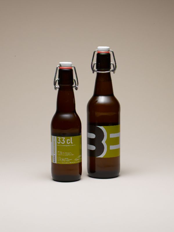 Two brown flip-top bottles of Biera Engiadinaisa beer with minimalist green and black labels.