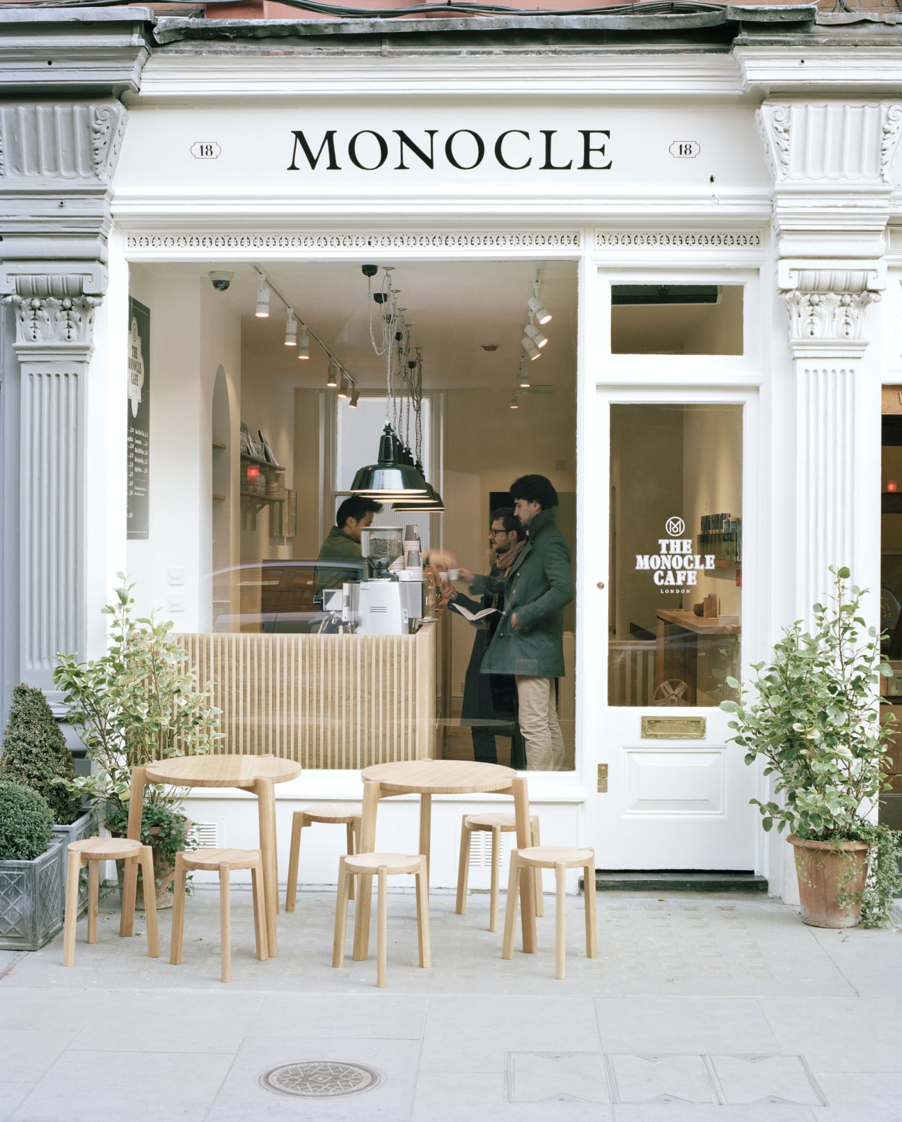 The Monocle Café storefront at 18 Chiltern Street with outdoor seating and white classical architecture.