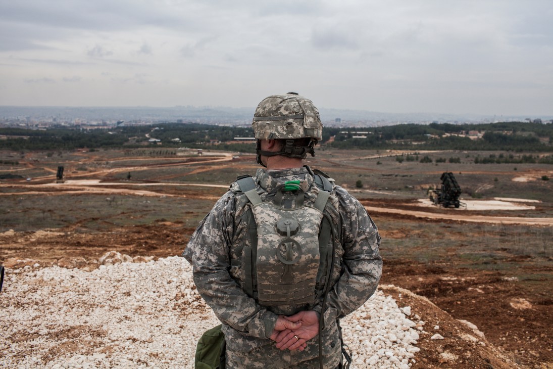 American military officer in camouflage uniform overlooking Gaziantep valley from elevated terrain.