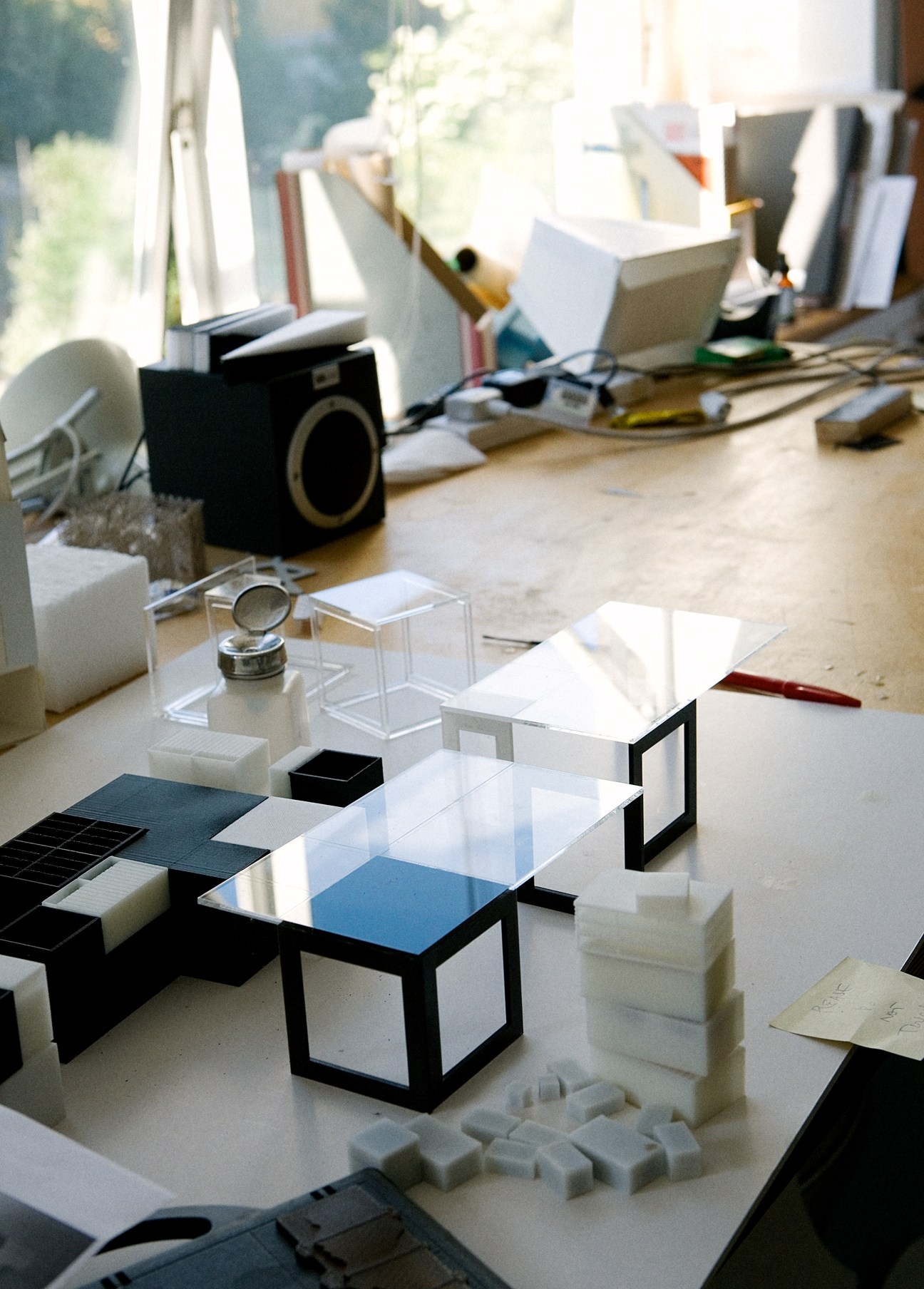 Design models and architectural prototypes displayed on a work table in Arup's studio.