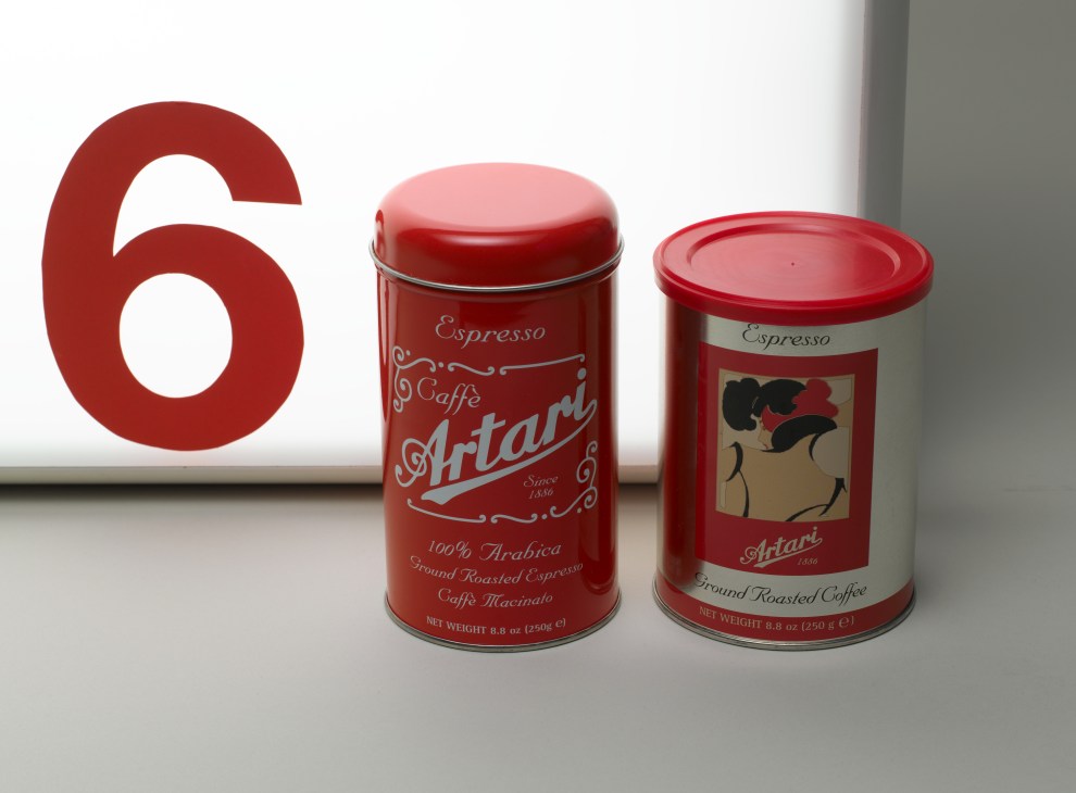 Two red Artari coffee tins with retro packaging displayed next to a large red number 6.