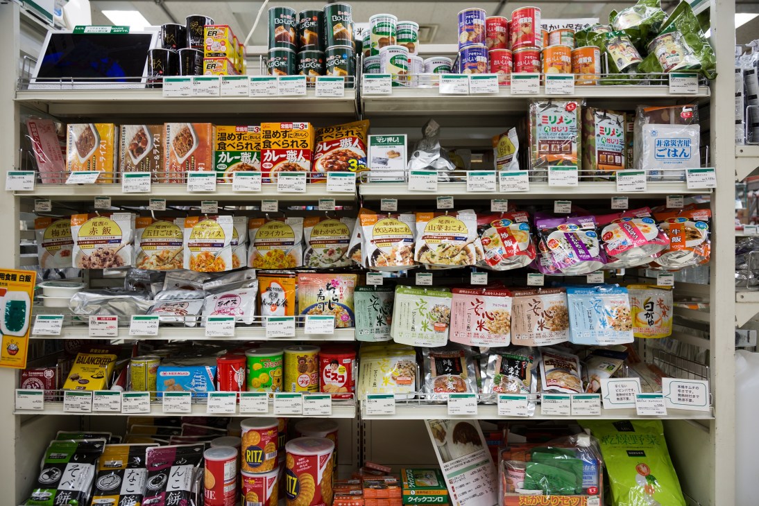 Shelves displaying various dried foods and emergency supplies in packaged containers and boxes.