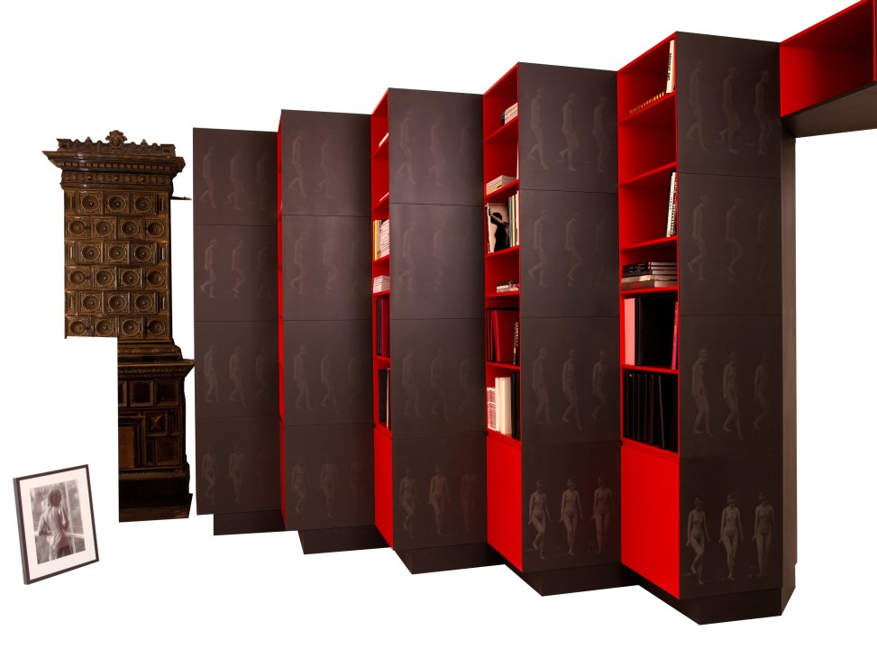 Red and black zigzag wall with Eadweard Muybridge images etched on black Valchromat panels and bright-red lacquered shelving.