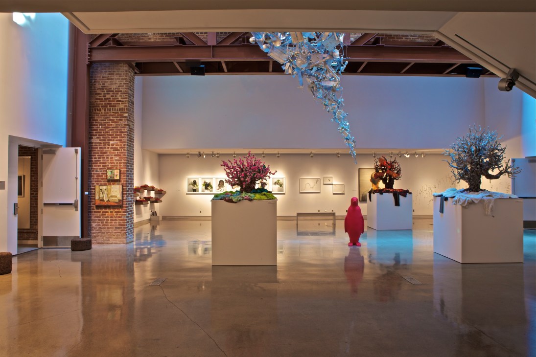 Contemporary art gallery interior with sculptural installations and colorful botanical artwork displays at 21c Museum Hotels Louisville.