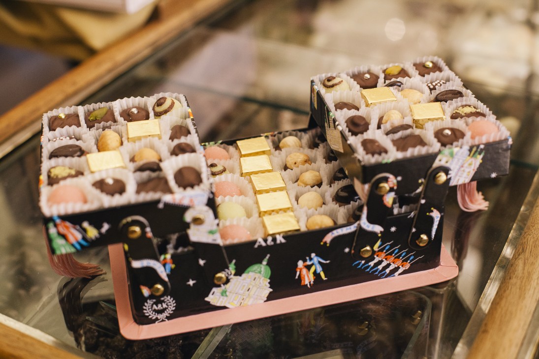 Handmade chocolate bonbons in colorful boxes at Altmann & Kühne confectionery in Vienna.