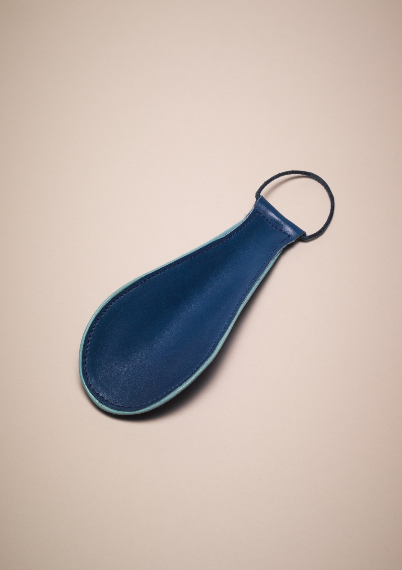 Blue leather shoehorn with ring handle made by Scheer in Vienna.