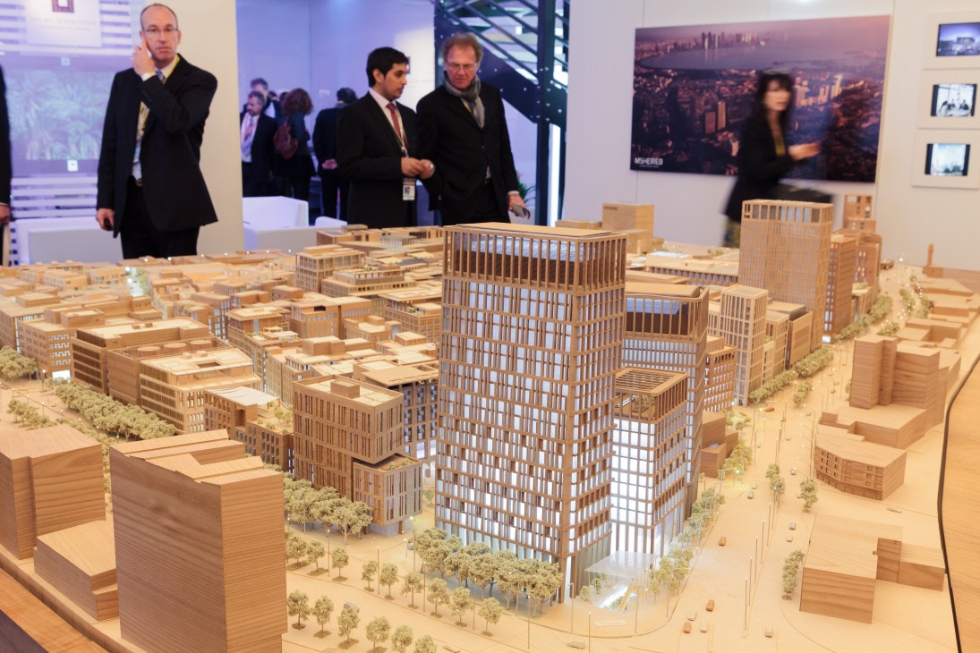 Architectural model of Doha masterplan by Msheireb Properties displayed at Mipim with visitors observing.