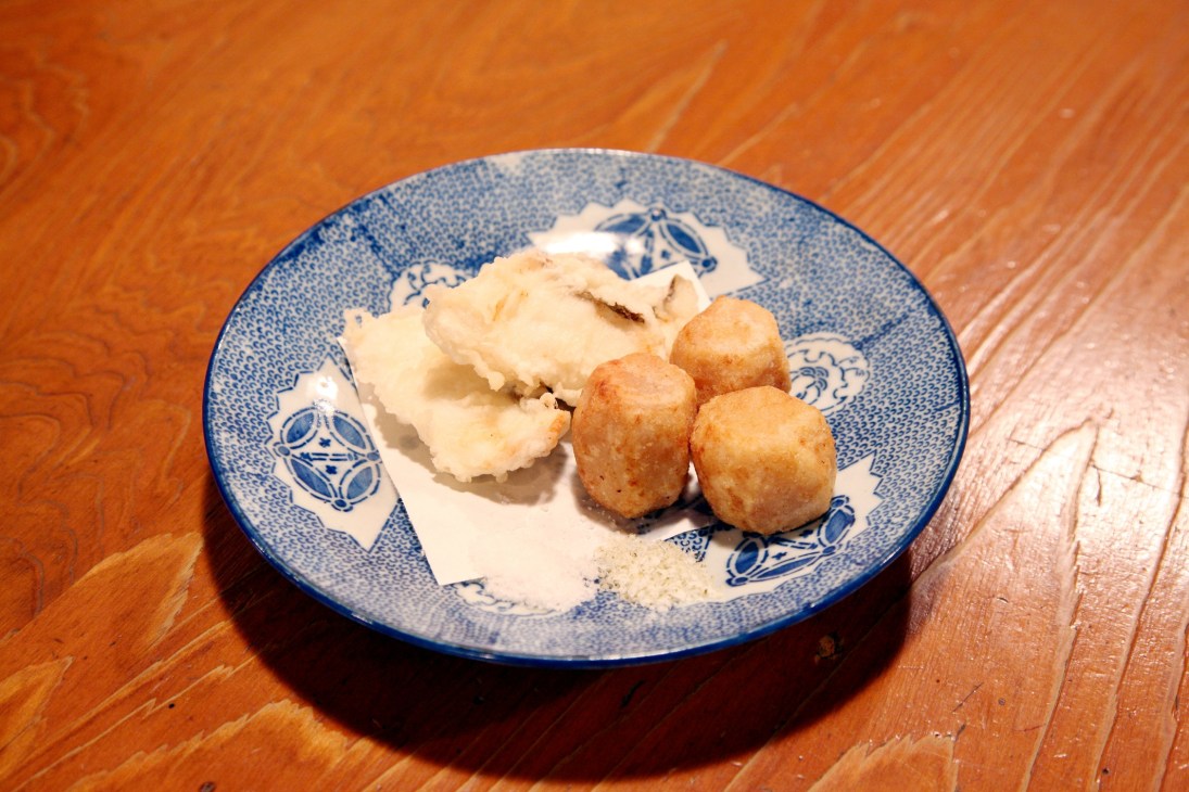 Tai tempura and deep-fried sato-imo on a blue and white ceramic plate.