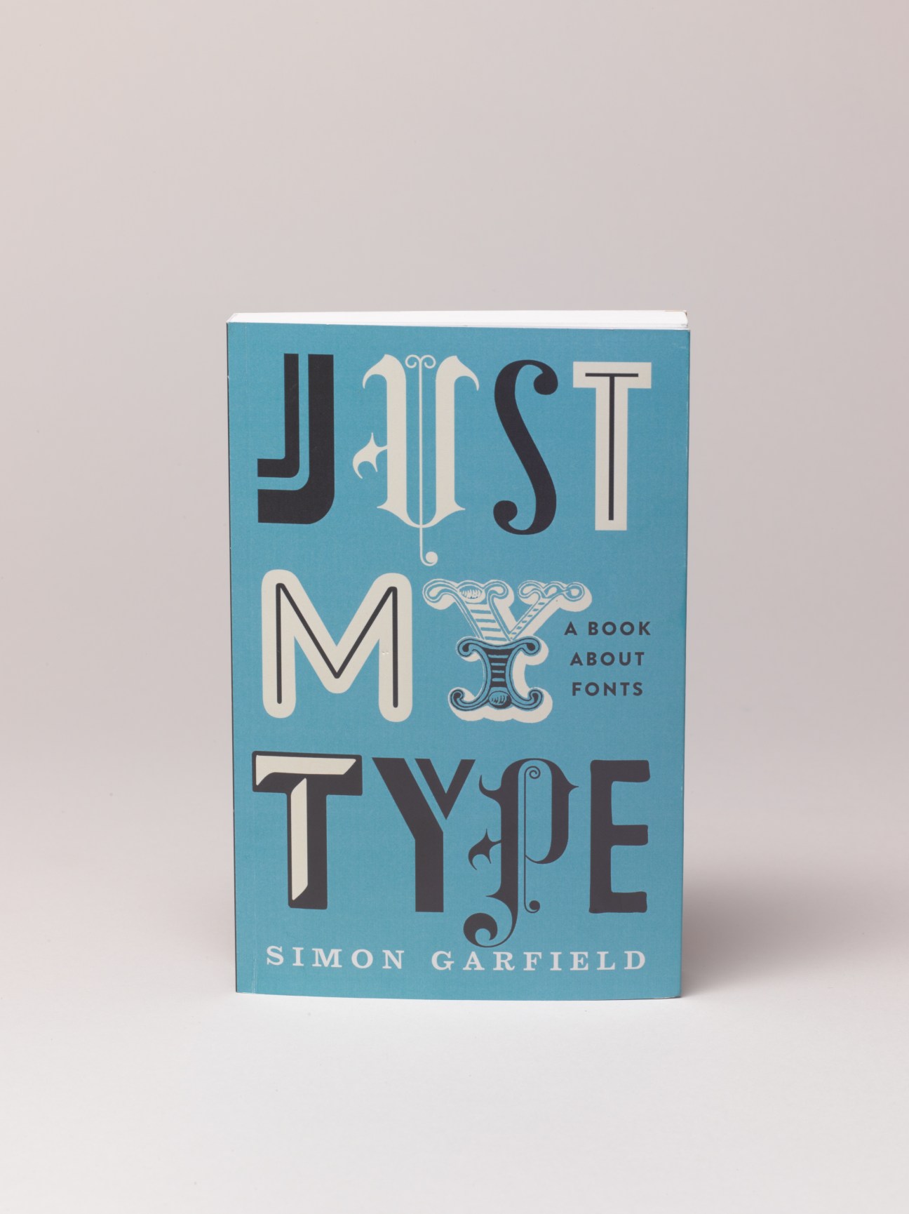Just My Type book cover by Simon Garfield featuring decorative typography on blue background.