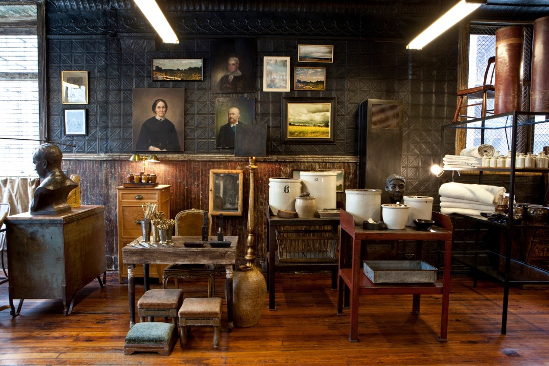 Interior of Hollander & Lexer store displaying vintage furniture, portraits, ceramics and decorative objects.