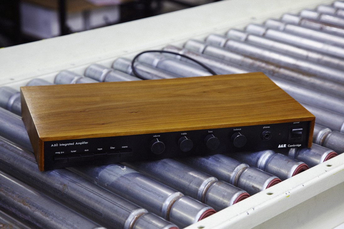 Arcam A60 Integrated Amplifier with wood casing displayed on electronic components.