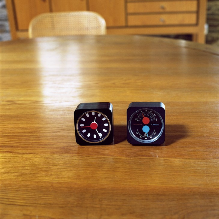 A clock for Habitat and barometer for Taylor Instruments designed by Kenneth Grange, displayed on a wooden table.