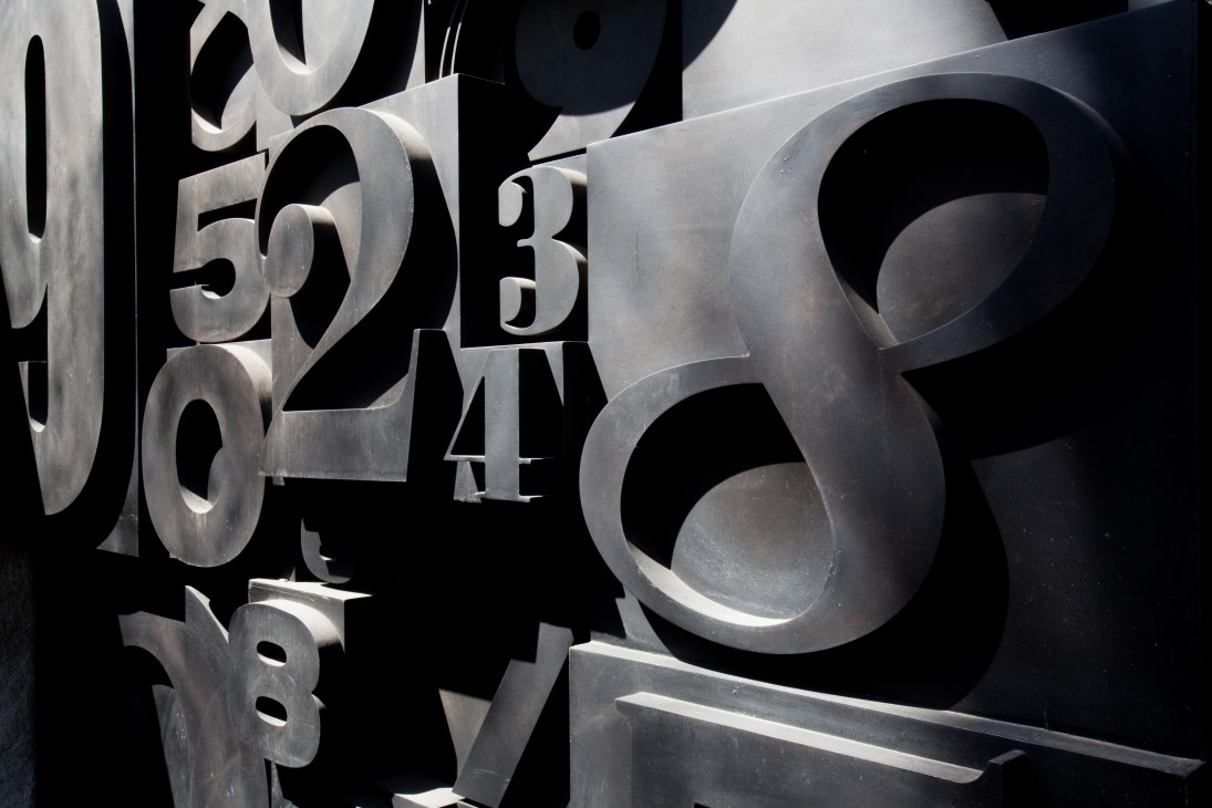 Large metallic letterpress numbers forming Numero nightclub's striking façade in São Paulo.