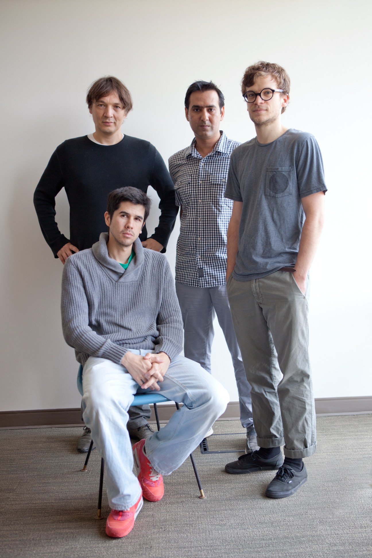 Four men posing for a portrait in a white room, representing the Disney Research team.