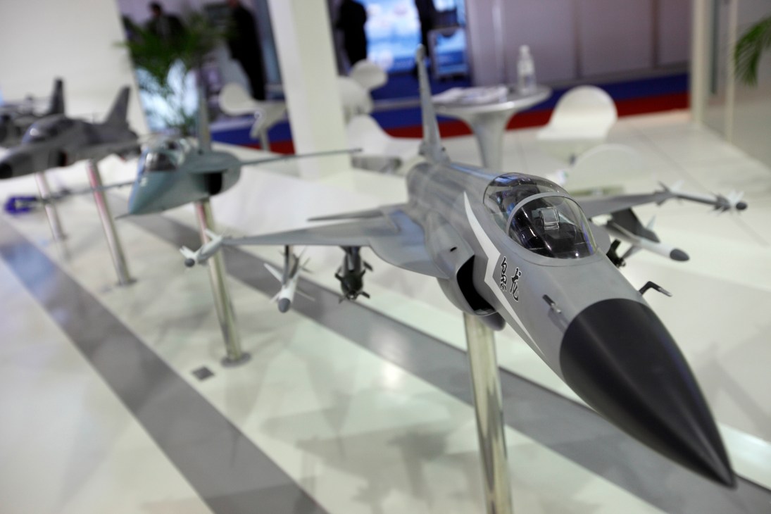 Scale model of FC-1 fighter jet displayed at Singapore Air Show exhibition.