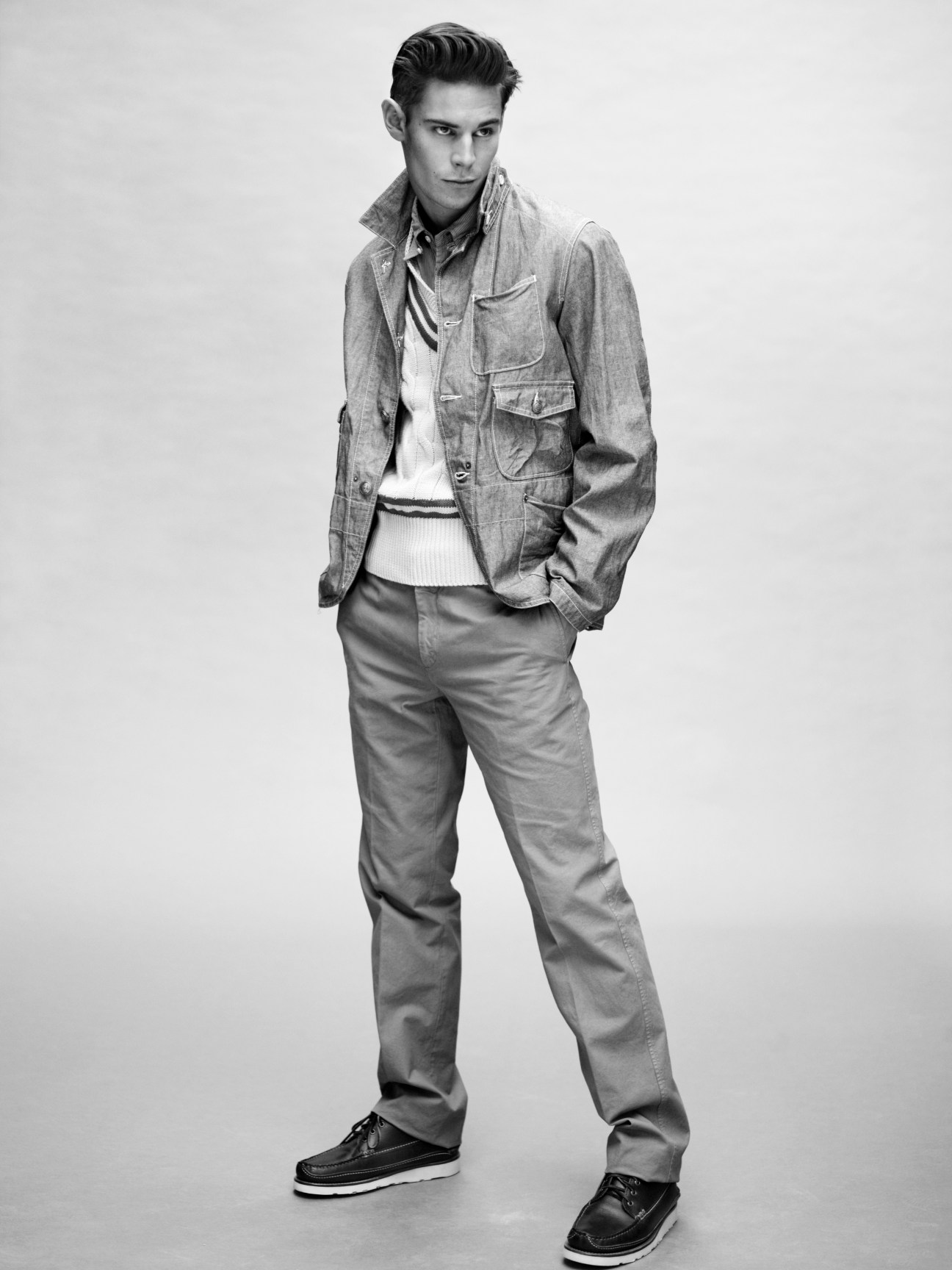 Model wearing Engineered Garments jacket and shirt with Nigel Cabourn tank top, Piombo trousers and Yuketen shoes.