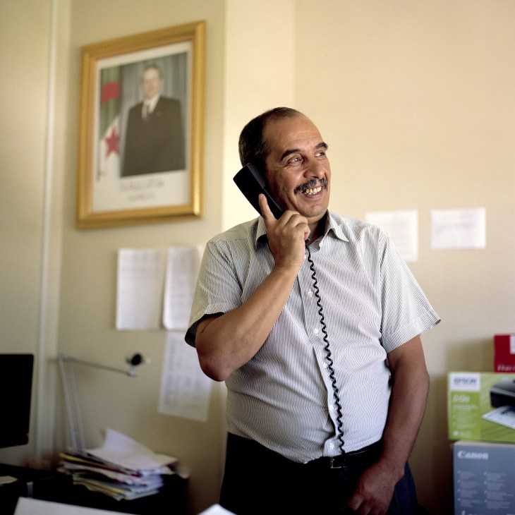 Mourad Betrouni speaks on a telephone in his Ministry of Culture office.