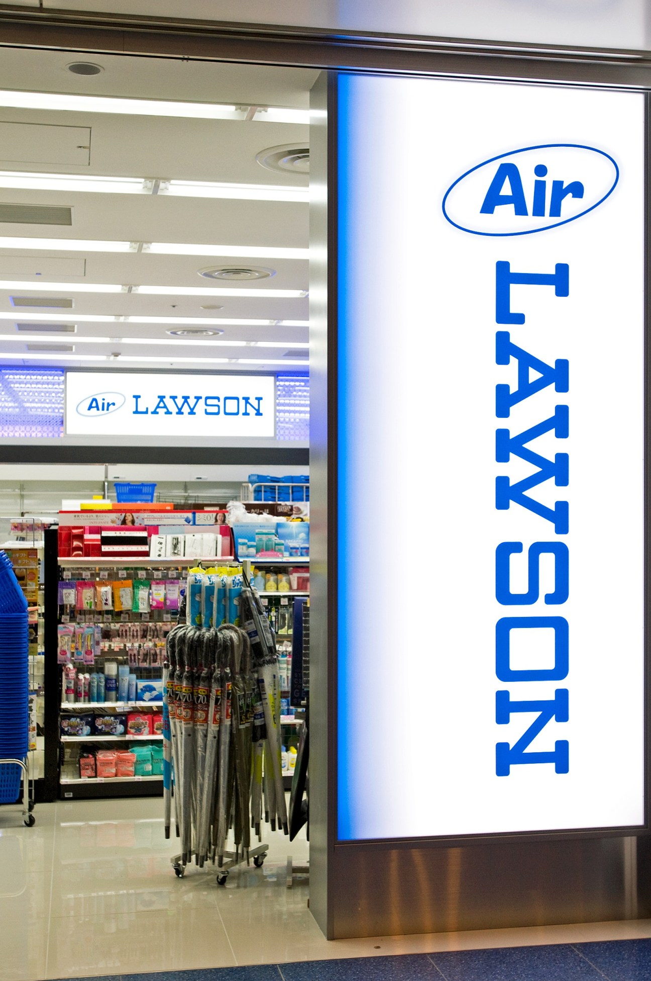 Air Lawson convenience store storefront with blue signage and product displays inside Haneda Airport terminal.