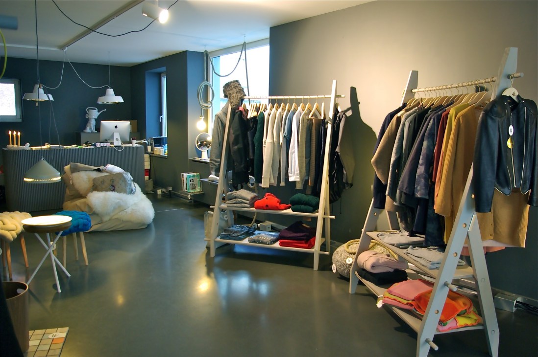 Interior of Waldraud concept store in Zürich showing clothing racks, display shelves, and minimalist retail design.