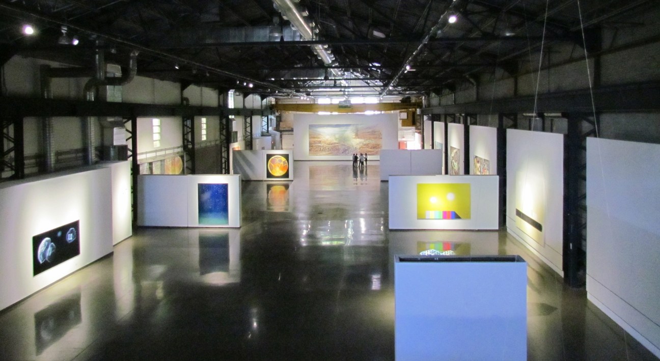 Interior of Arsenal gallery in Toronto showing contemporary artworks displayed on white walls and pedestals in a converted industrial space.