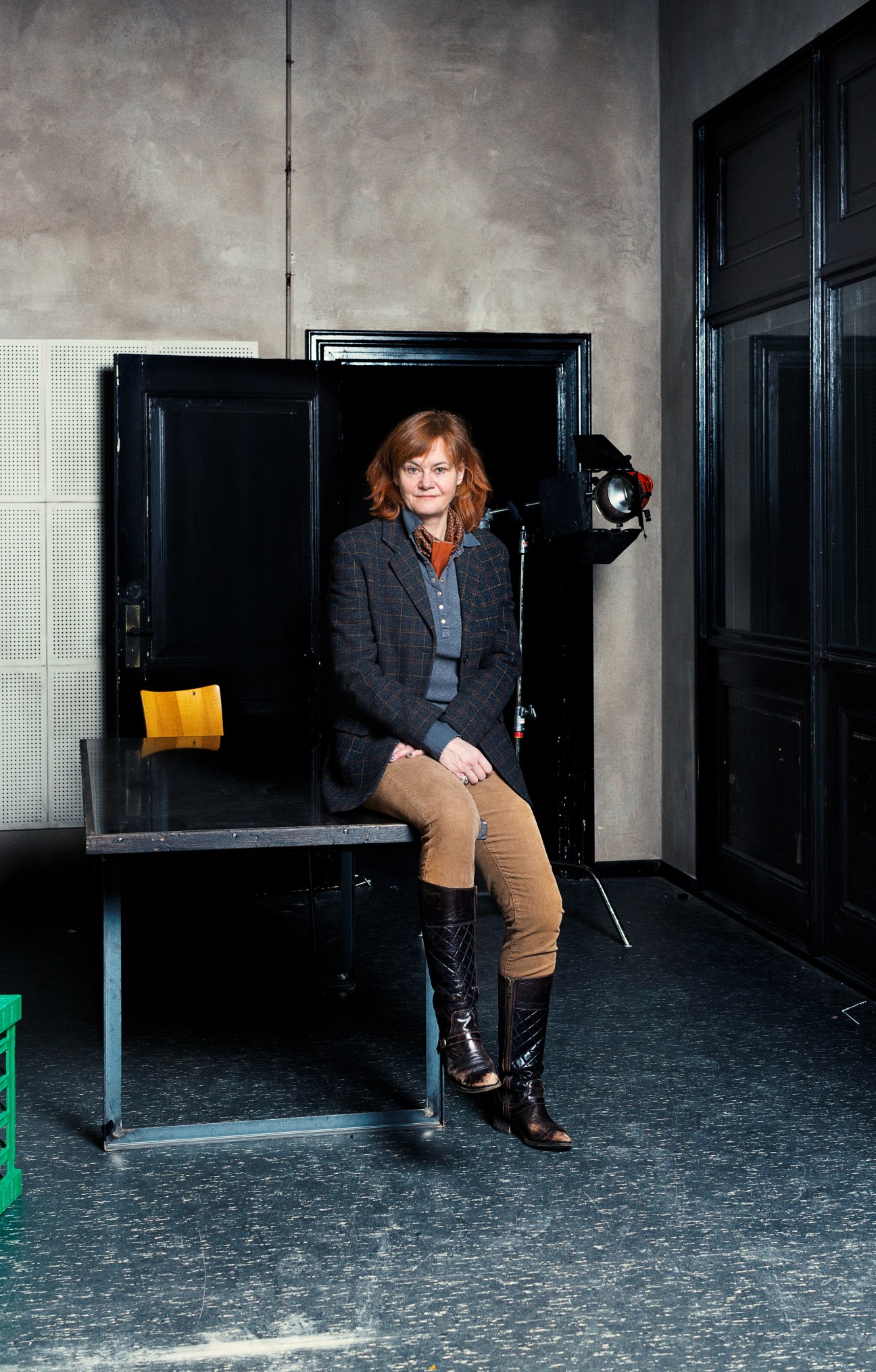 Piv Bernth, co-head of drama at Danmarks Radio, sits in a studio set with black frames and professional lighting equipment.