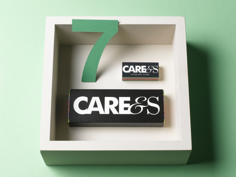Care&s fabric care tablets and branding displayed in a minimalist white box with green number seven.