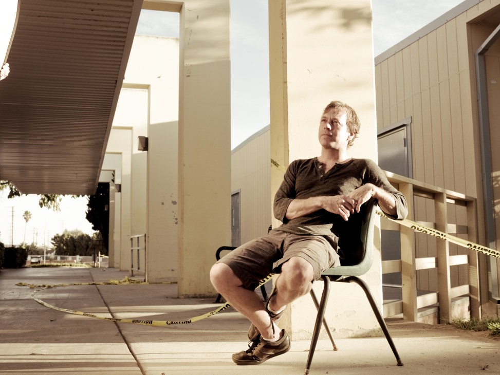 Chris Douridas sits outside KCRW's Santa Monica College facility in casual clothing.