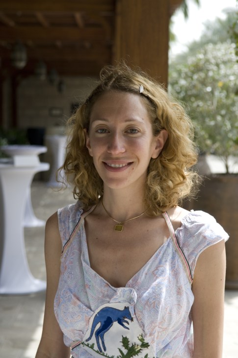 Claudia Cellini, co-director of The Third Line gallery, smiles at the camera outdoors in Dubai.