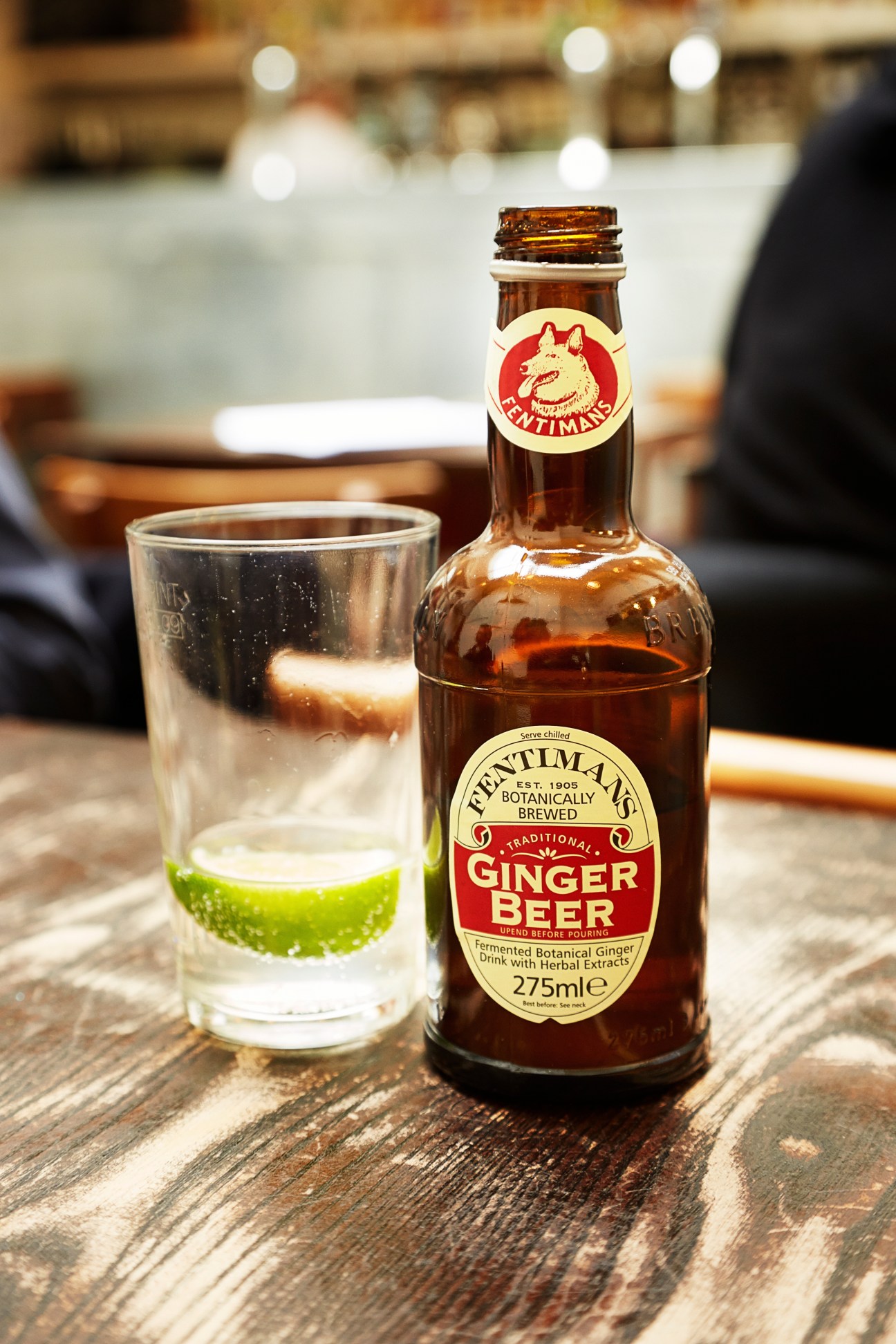 Fentimans ginger beer bottle with glass of ginger beer and lime at St John restaurant.