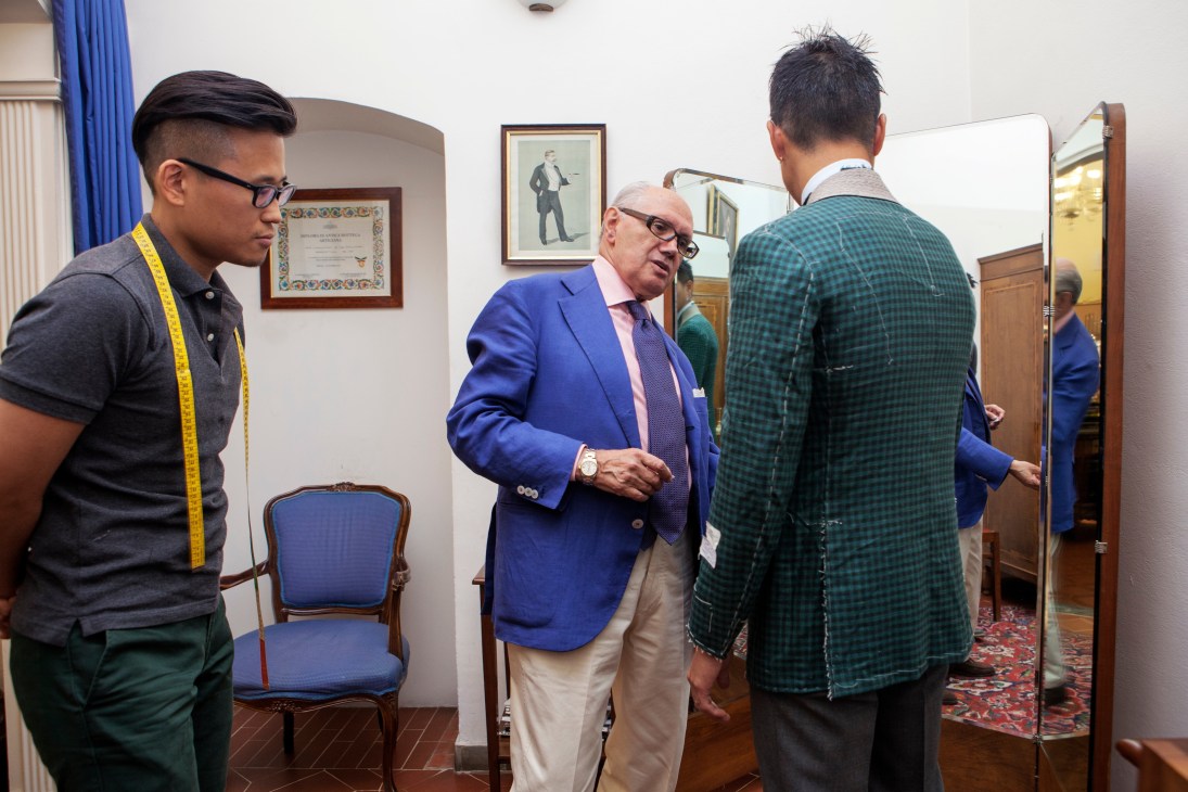 Hojun Choi observes as master tailor Antonio Liverano adjusts a suit on a client during a fitting at Liverano & Liverano.