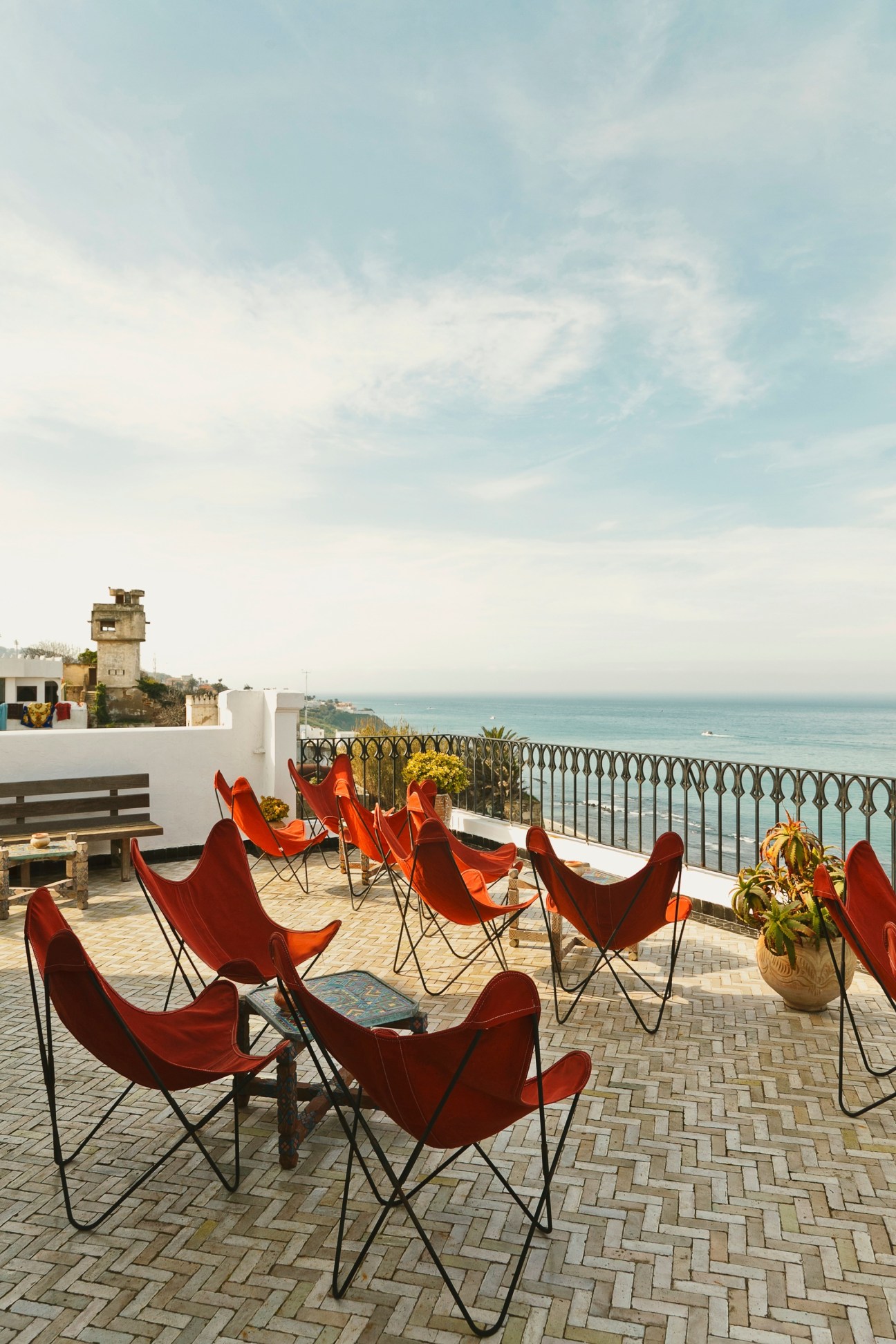 Red butterfly chairs on a terrace overlooking the Strait of Gibraltar at the Nord Pinus hotel in Tangier.