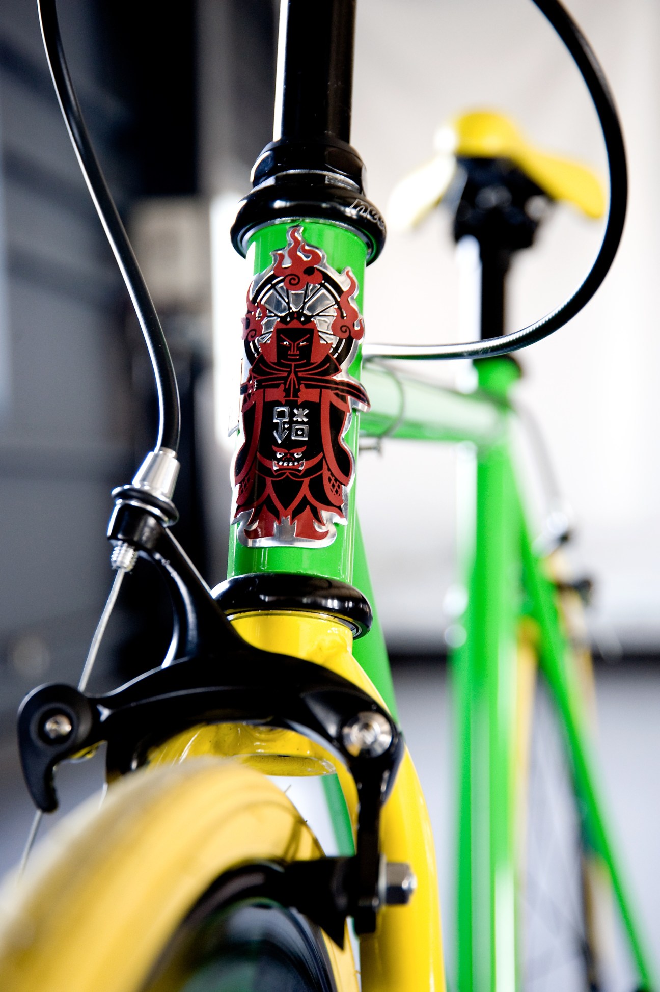 Close-up of a Funriki bicycle headset showing the red and green Idaten logo with Buddhist deity design.